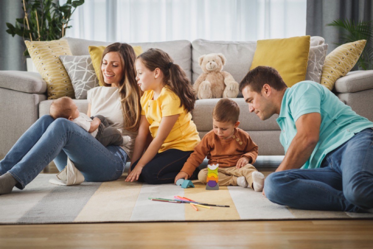 A family relaxing and playing together in a warm living room